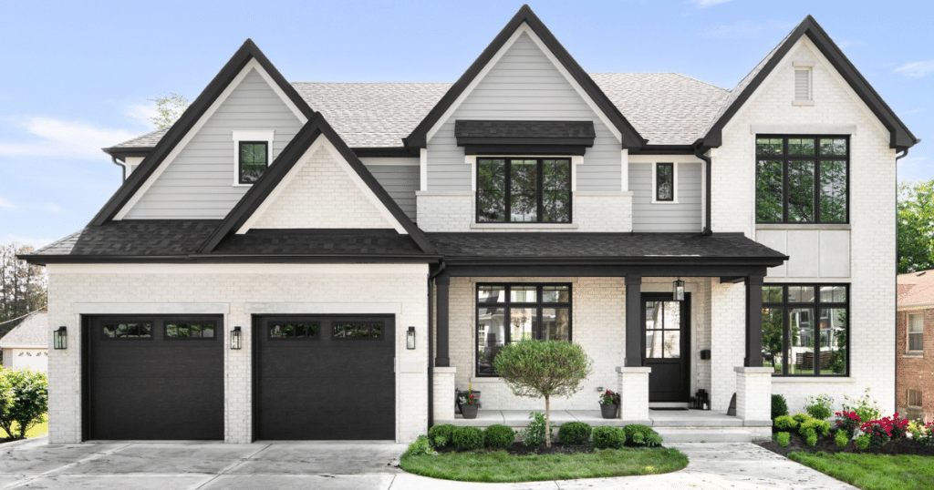 white house with black garage doors