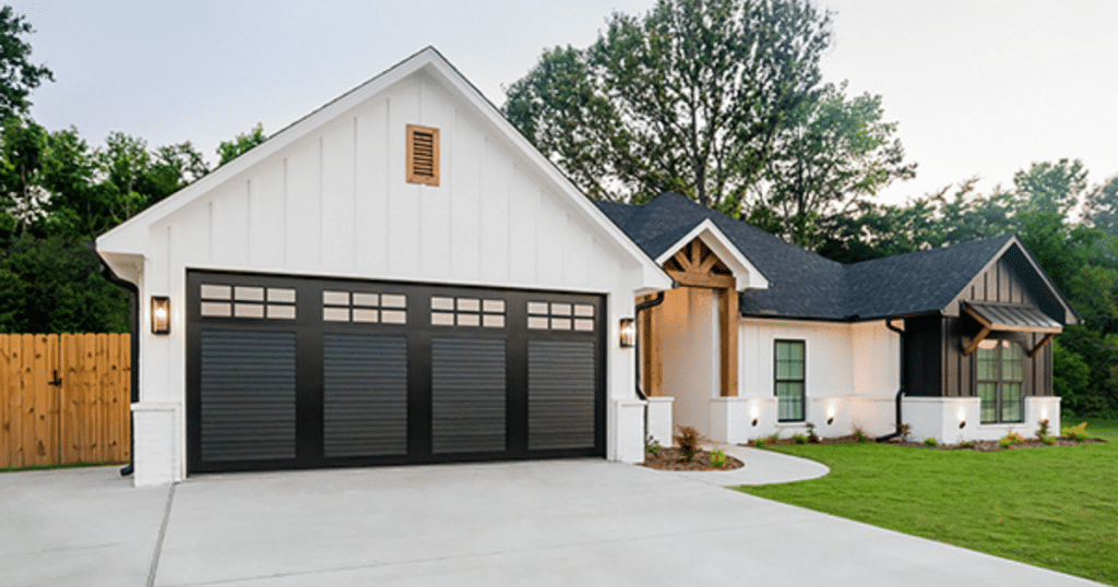 black garage door in a white house