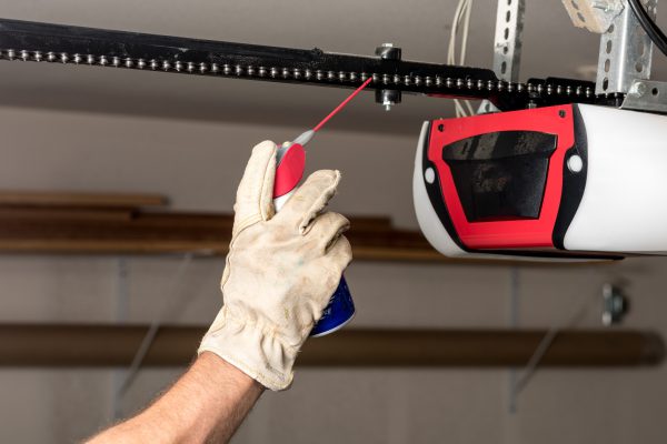 Applying oil to a chain of a garage door opener Applying oil to a chain of a garage door opener